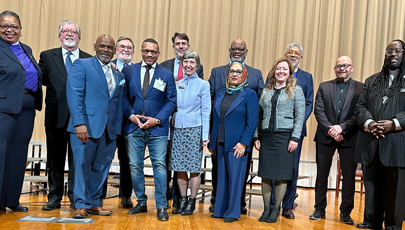 Group of faith leaders and other community members pose for a photo at a Carter Center event