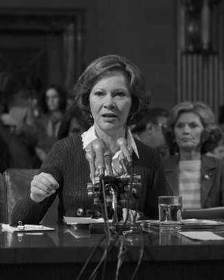 Rosalynn Carter speaking at a podium