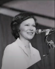 Rosalynn Carter speaking at a podium